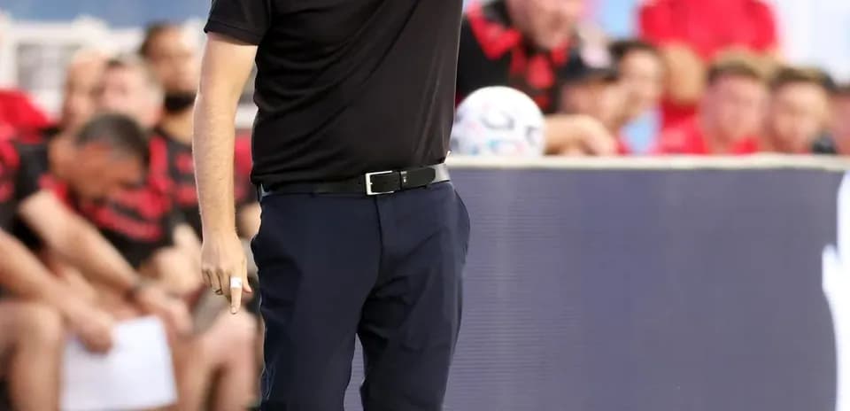 Coach giving instructions from the sideline during match