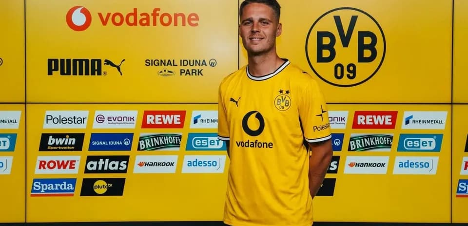 Player in yellow Borussia Dortmund jersey at press event