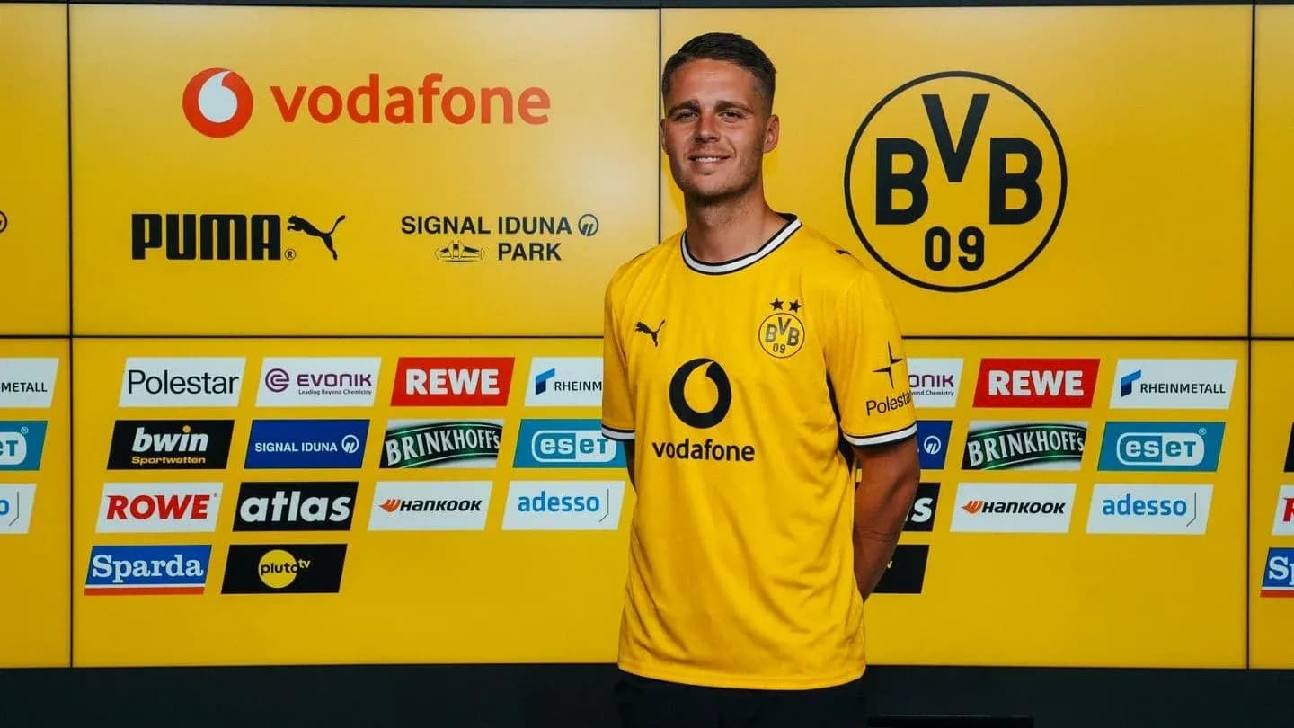 Player in yellow Borussia Dortmund jersey at press event