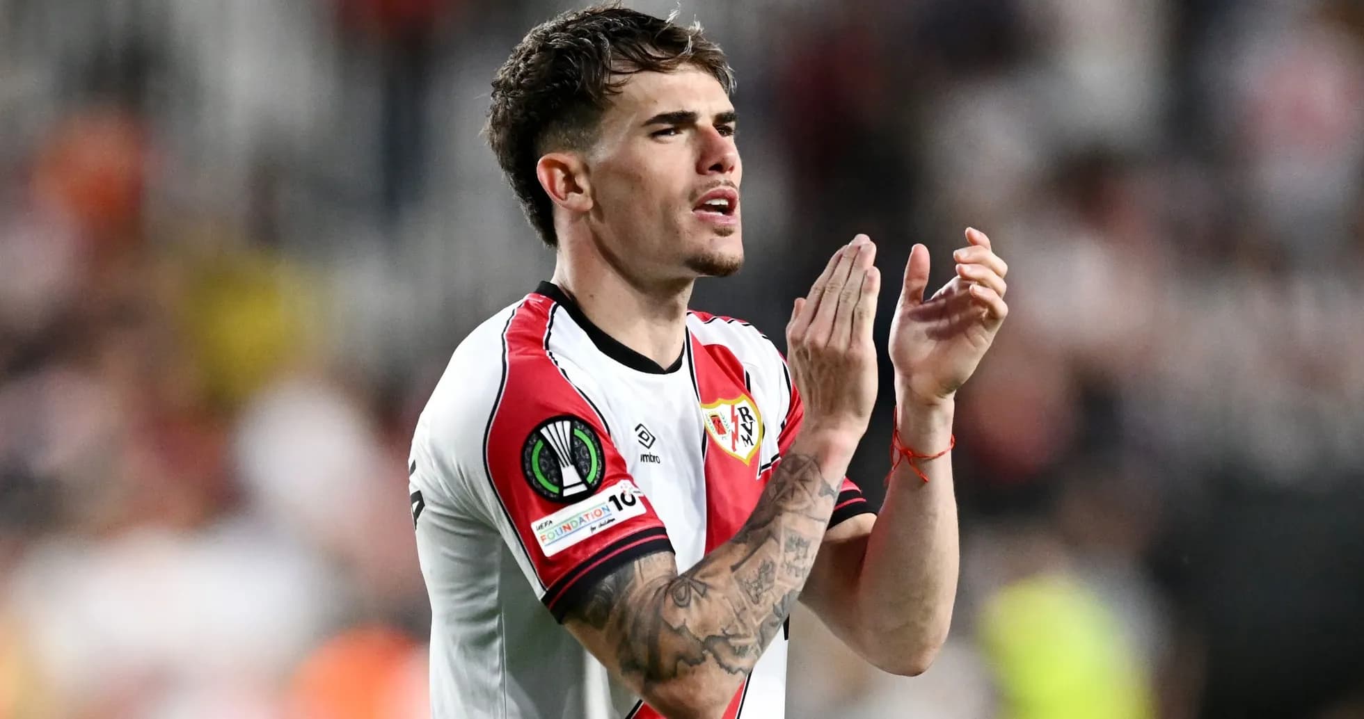 Player applauding fans during match at stadium