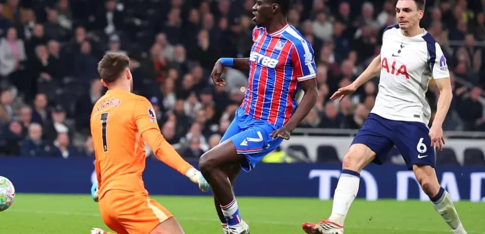 Crystal Palace player challenged by Tottenham goalkeeper