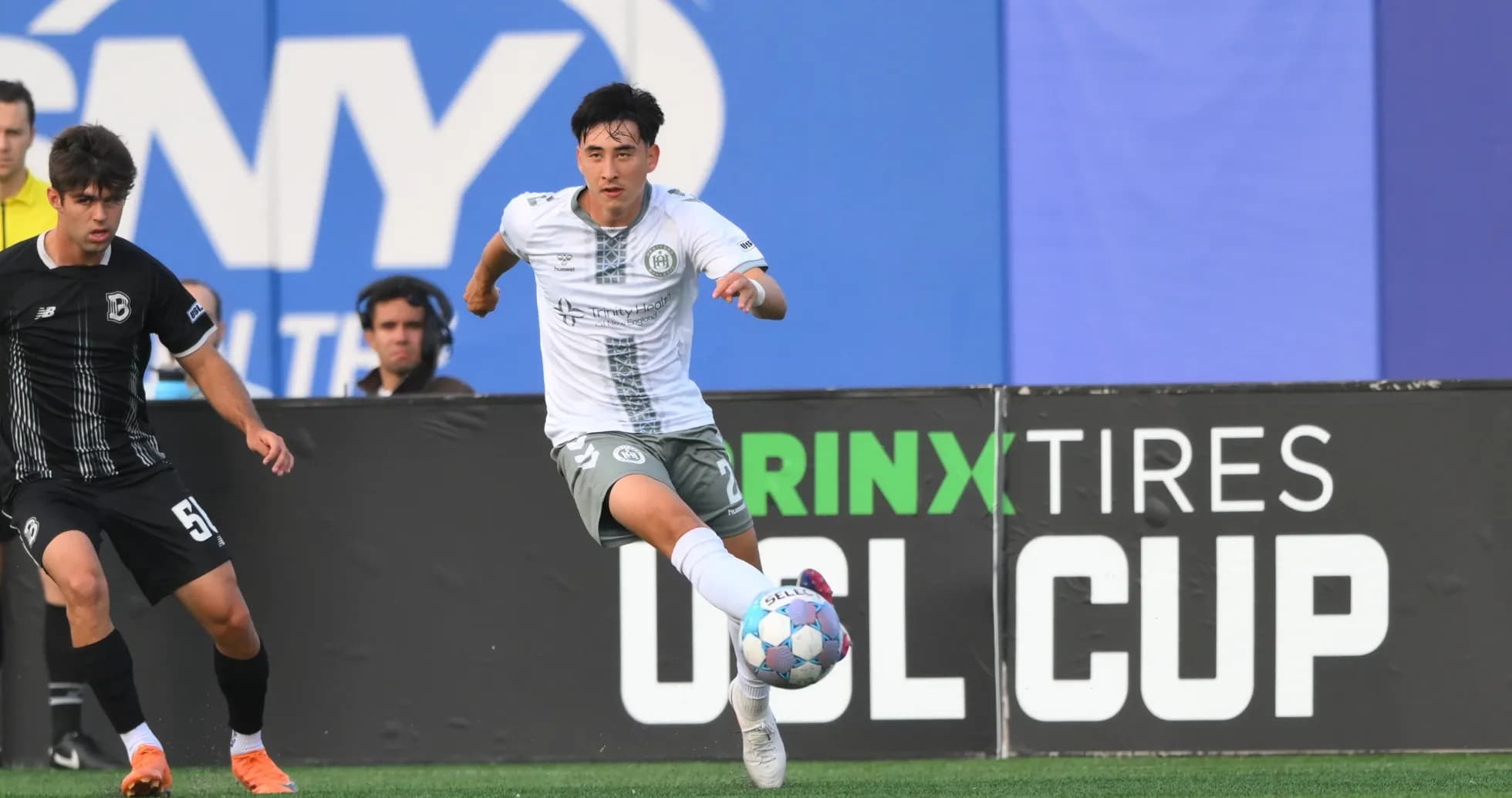 Player running with ball during USL Cup match