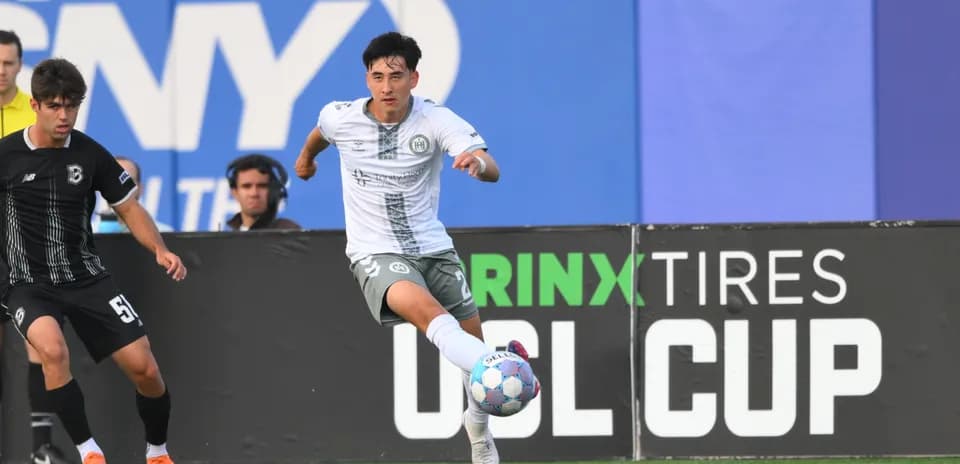 Player running with ball during USL Cup match