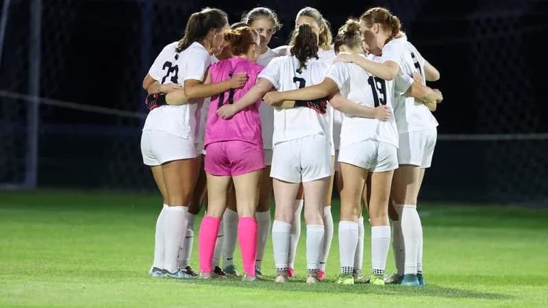 Team huddled together before the match