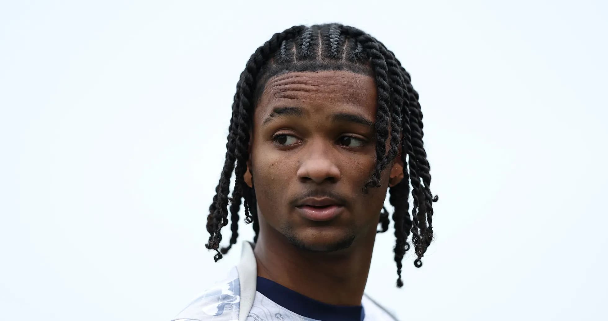 Young athlete with braided hair looking to the side