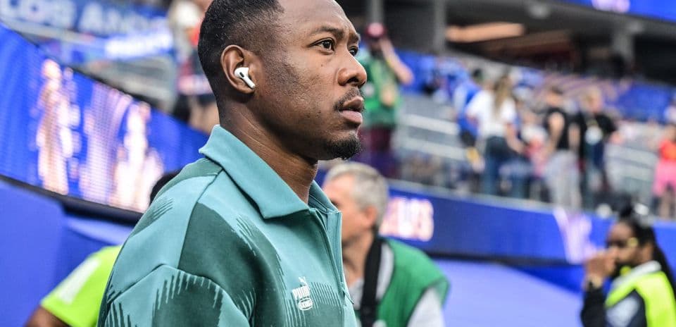 Player walking in stadium wearing headphones