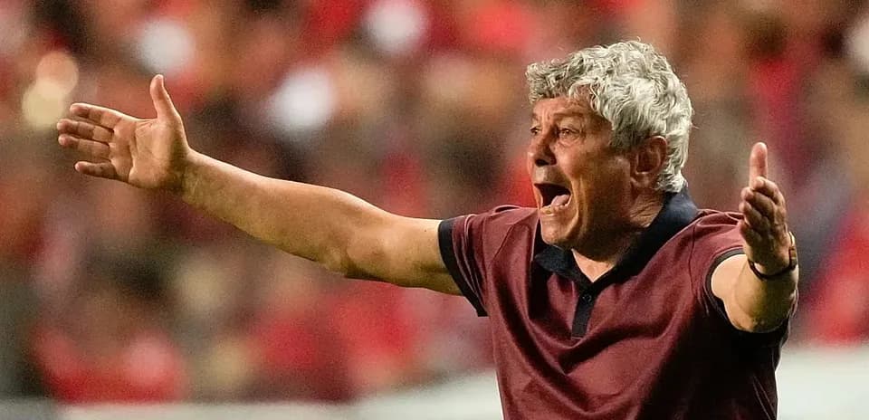 Coach gesturing passionately during match on sidelines