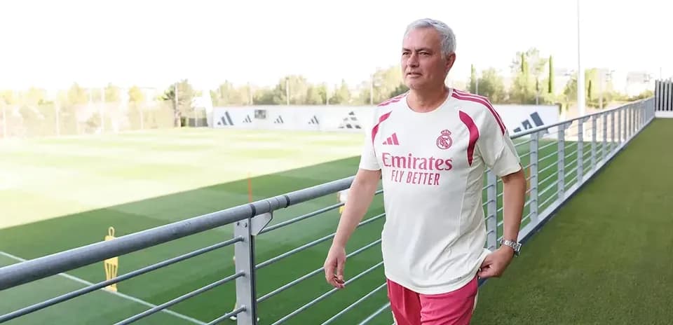 Manager walking on training pitch at facility