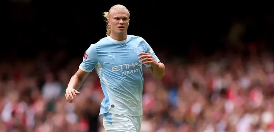 Player running on the pitch in Manchester City kit