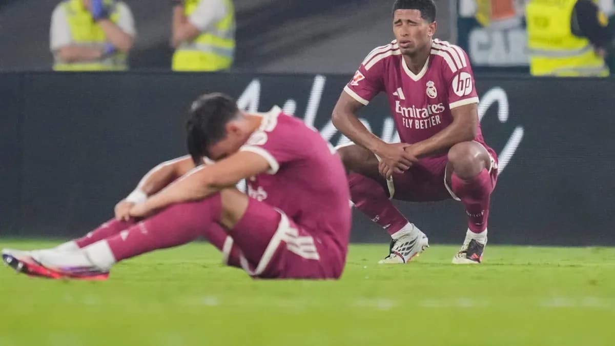 Two Real Madrid players sitting on the field