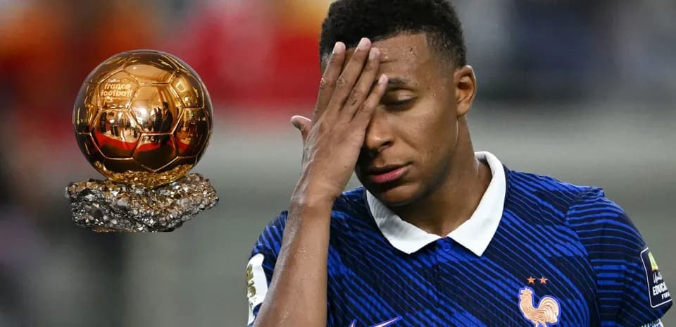 Player reacting with Ballon d'Or trophy nearby