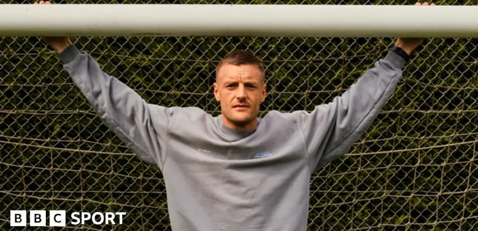Player posing with arms on goalpost netting