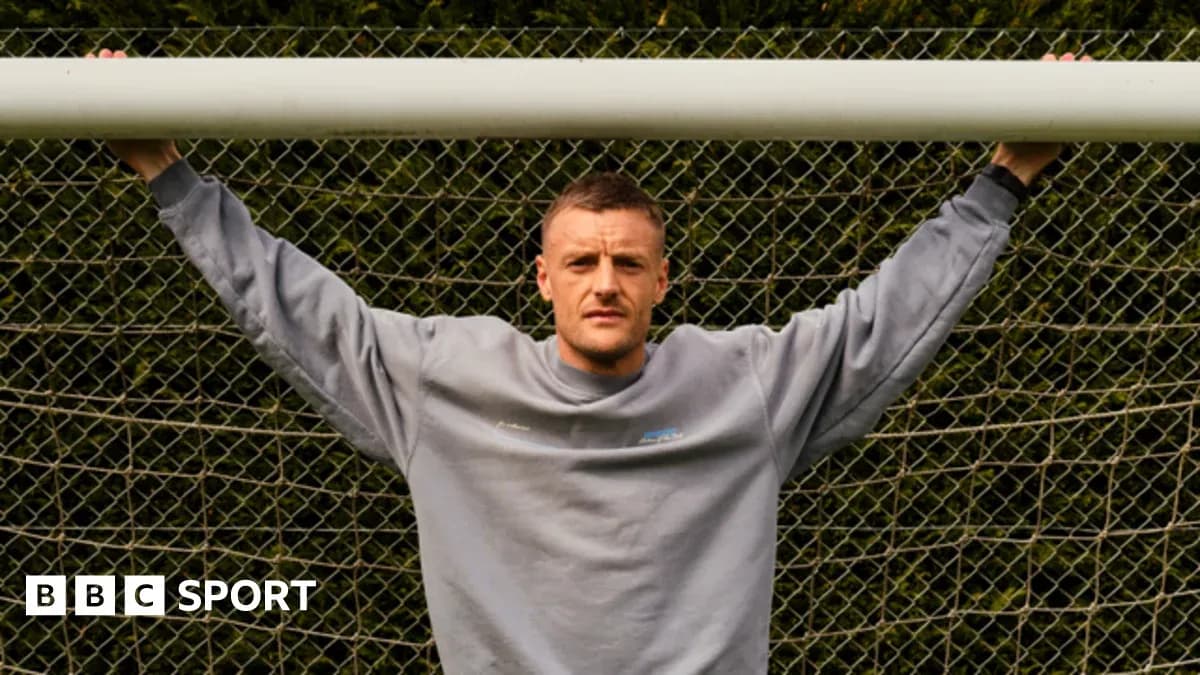 Player posing with arms on goalpost netting