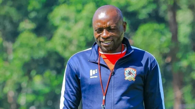 Coach walking on training ground with smile