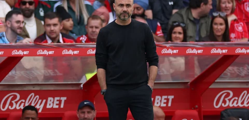 Coach standing on the sidelines during a match