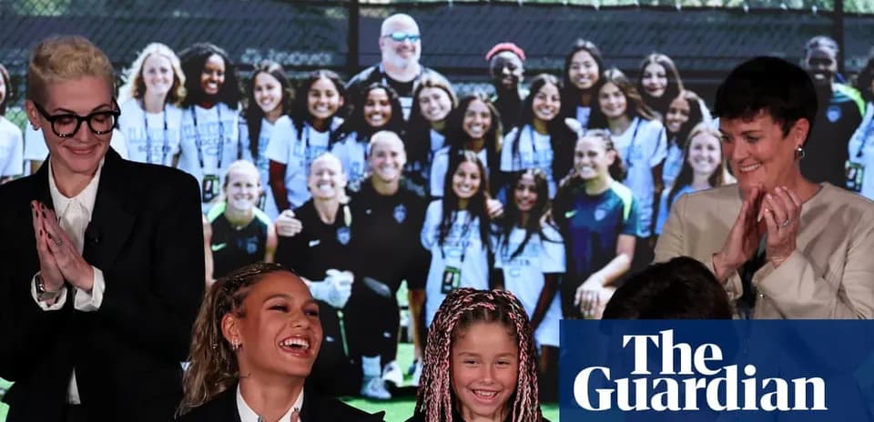 Women and children smiling at event with team photo backdrop