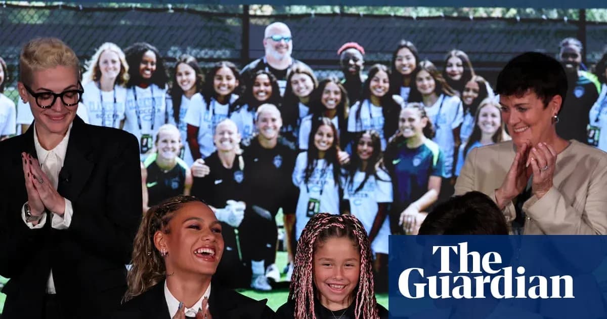 Women and children smiling at event with team photo backdrop