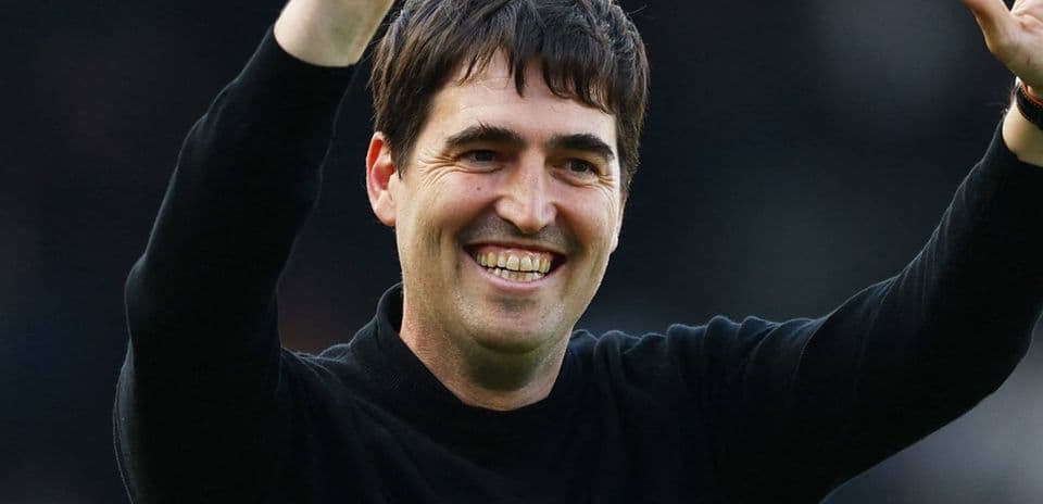 Coach celebrating with fans after a match