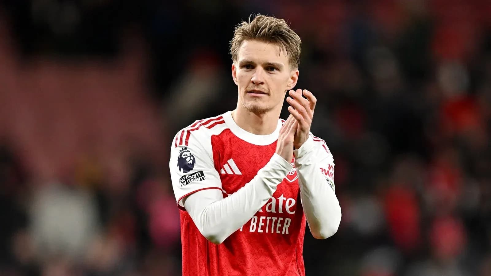 Player applauding fans after match at stadium