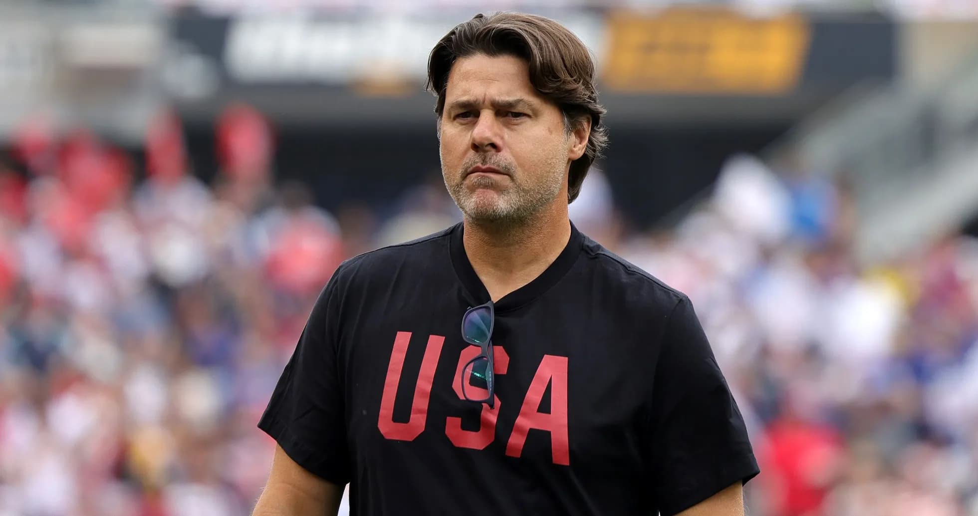 Coach walking on field in USA t-shirt