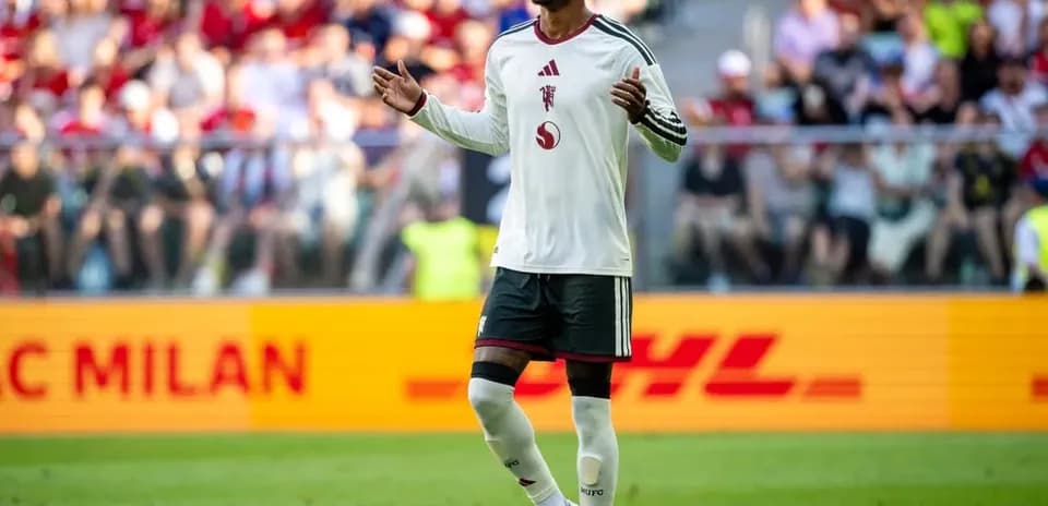 Player gesturing during match with fans in background