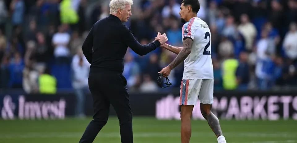 Coach and player shaking hands on the field