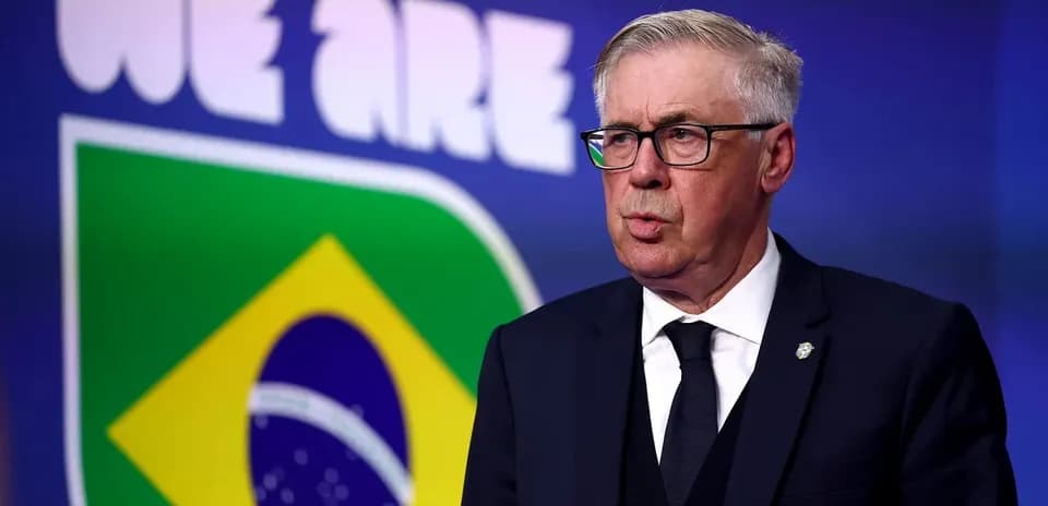Man speaking in front of Brazil football logo