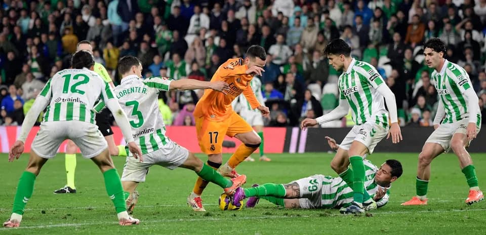 Players competing for the ball during Real Betis match