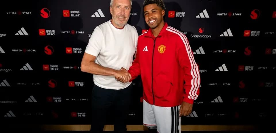 Two men shaking hands at a Manchester United event