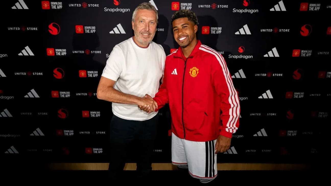 Two men shaking hands at a Manchester United event