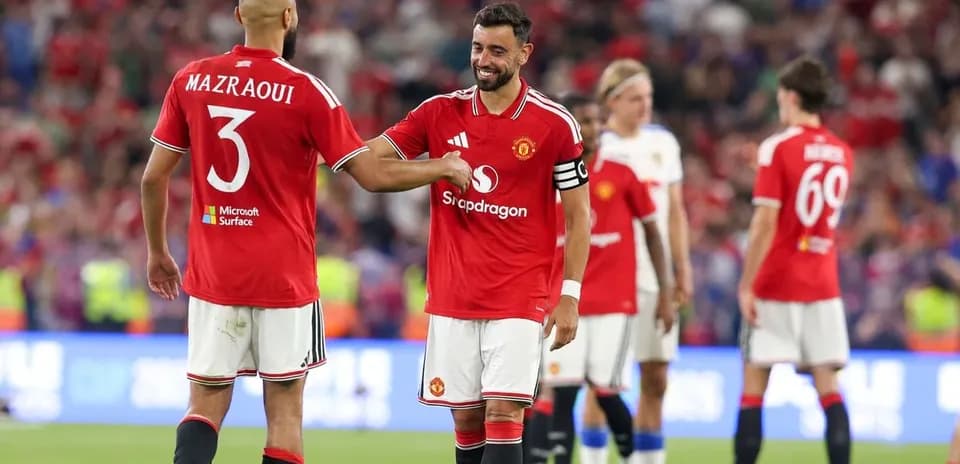 Two Manchester United players celebrating on the pitch