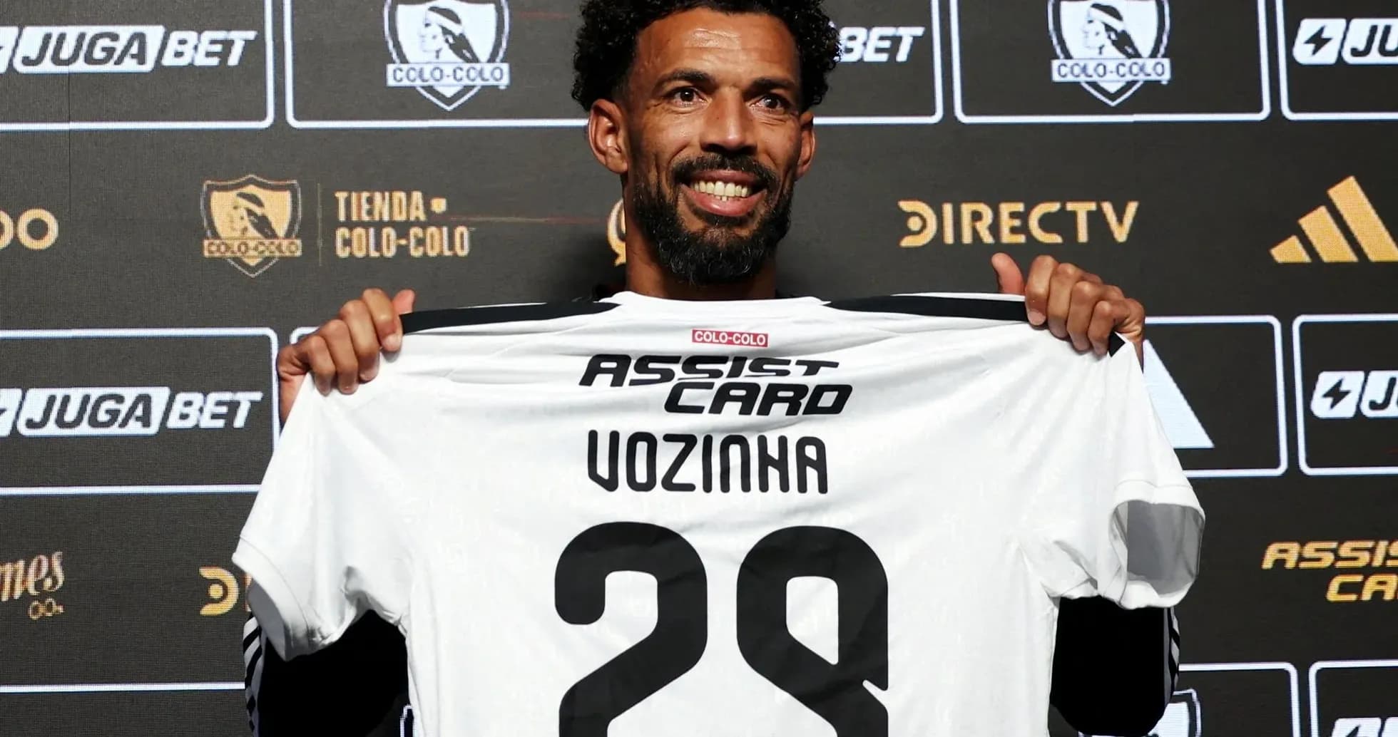 Player holding Colo-Colo jersey at press conference