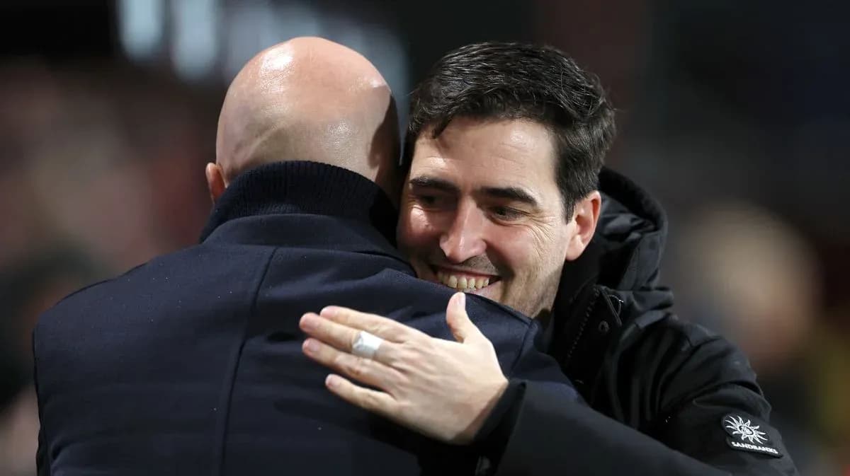 Two coaches embracing after a match