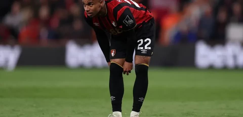 Player in Bournemouth kit resting during match