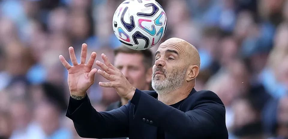 Coach attempting to catch ball during match