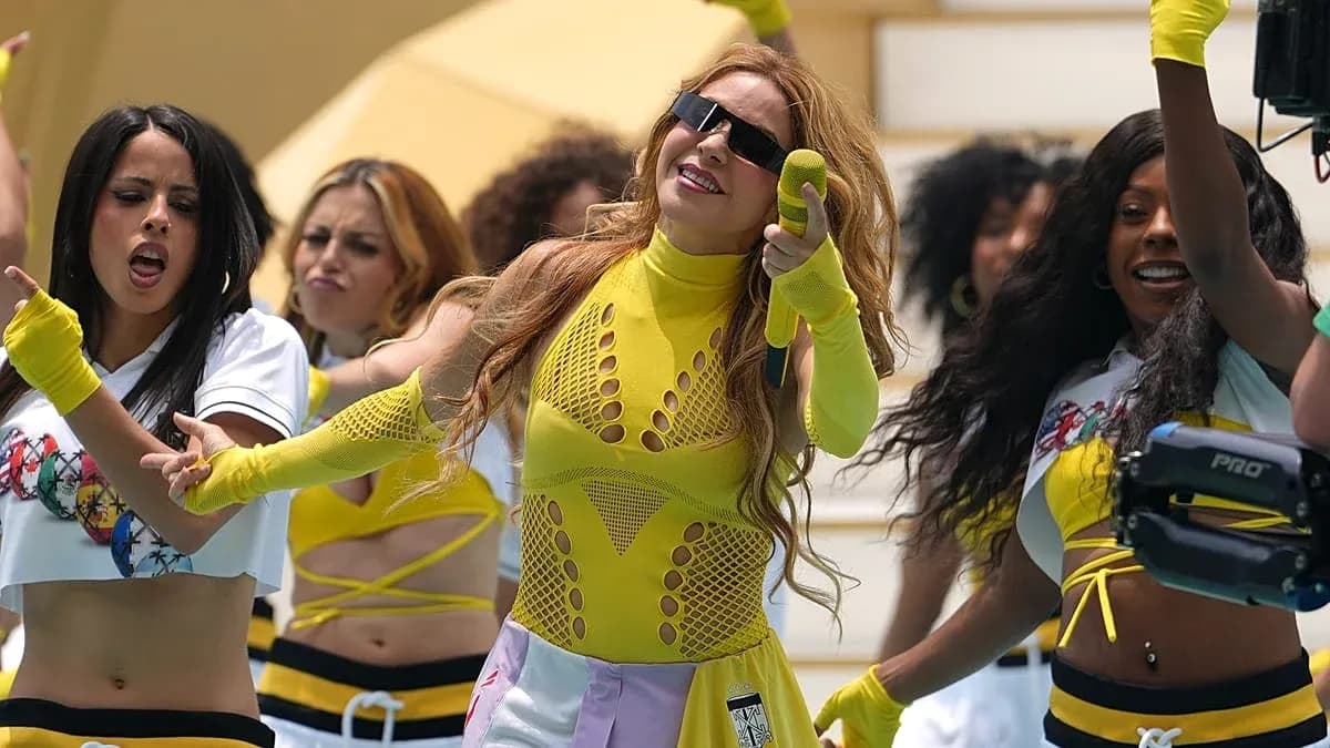 Performers dancing in bright outfits on stage