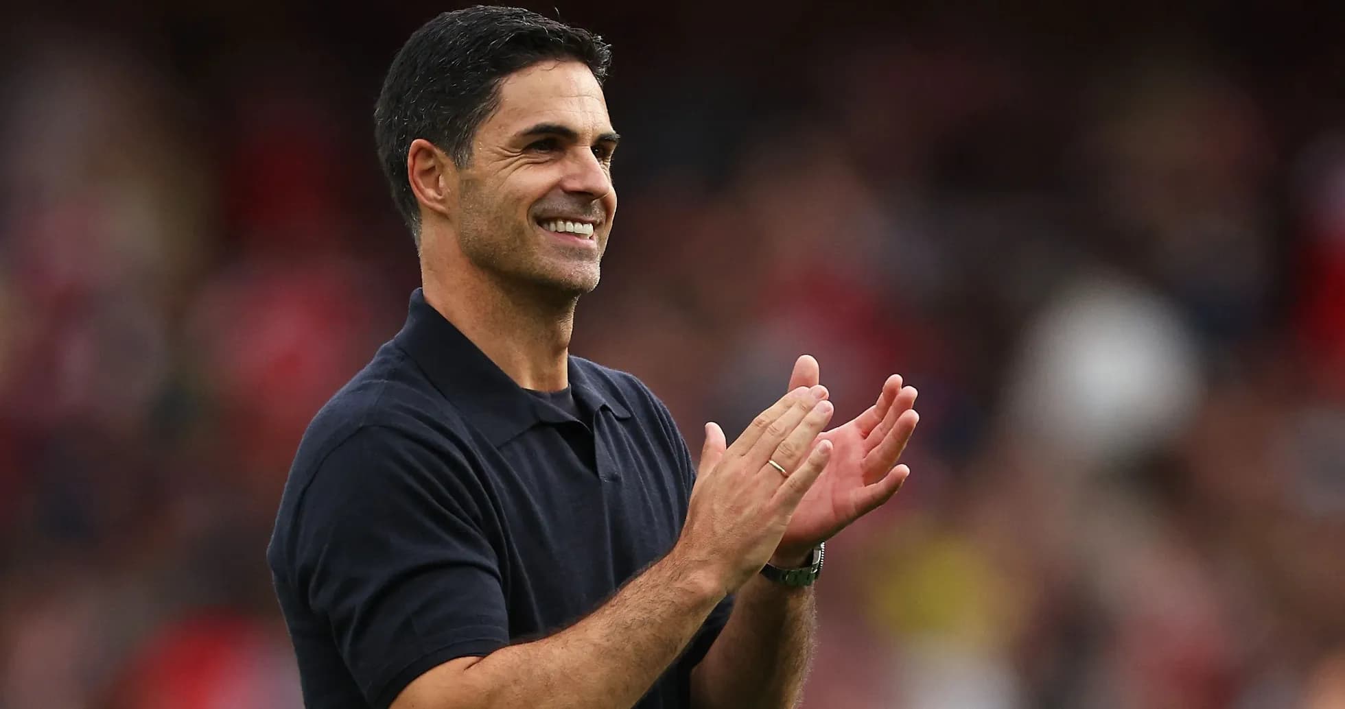 Coach applauding during a match at the stadium