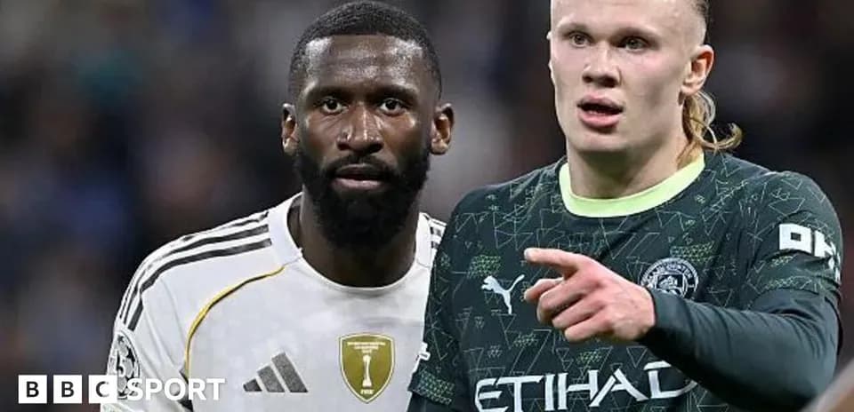 Two football players standing close during match