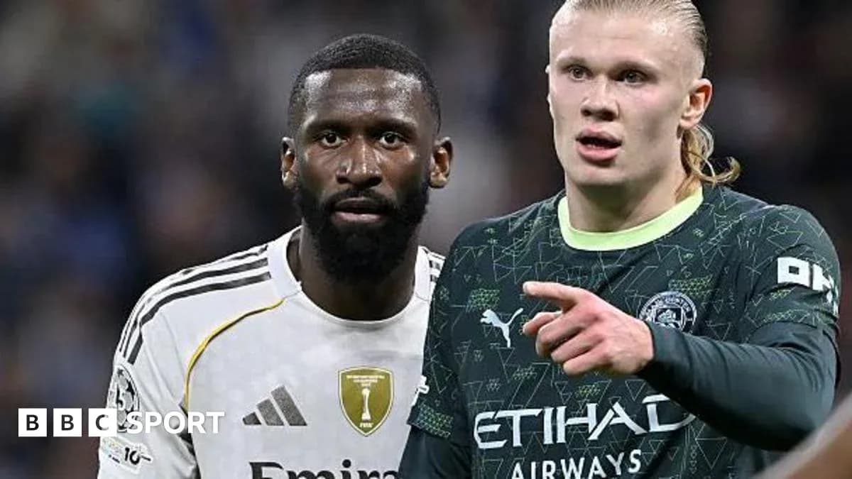 Two football players standing close during match