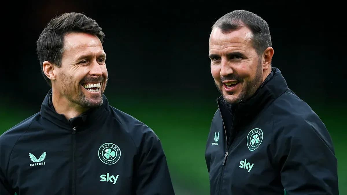 Two coaches smiling during a training session