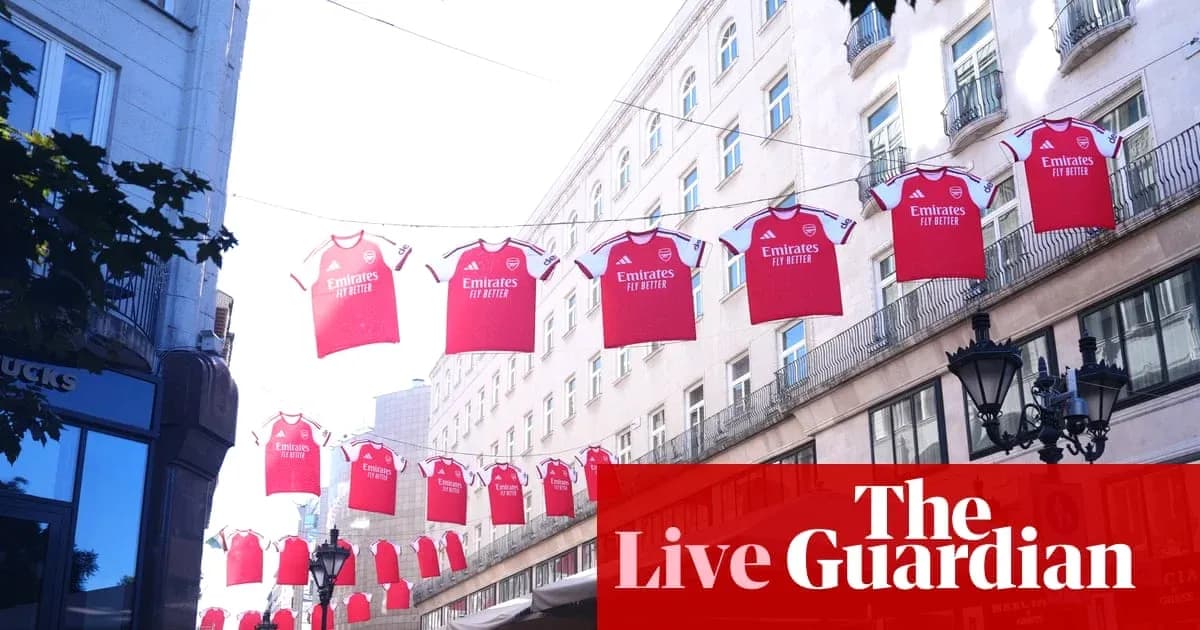 Red Arsenal jerseys hanging between buildings