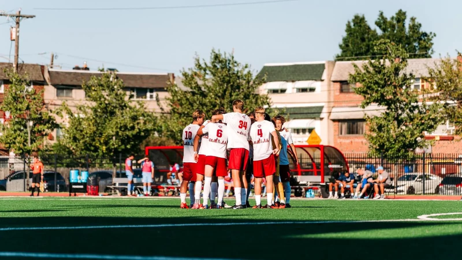 Players huddled together before the match