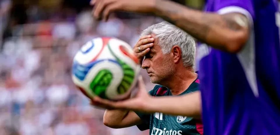 Coach holding head in frustration during match