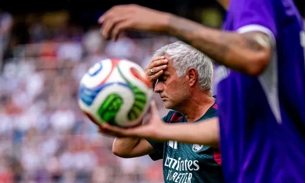 Coach holding head in frustration during match