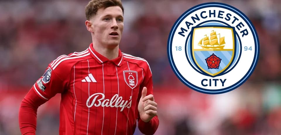 Player in red kit running with Manchester City logo
