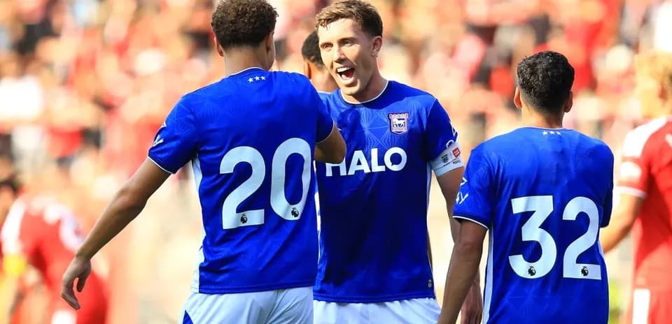 Players celebrating a goal in blue team jerseys