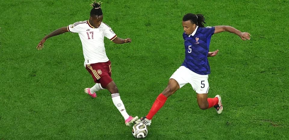 Two players competing for the ball during match