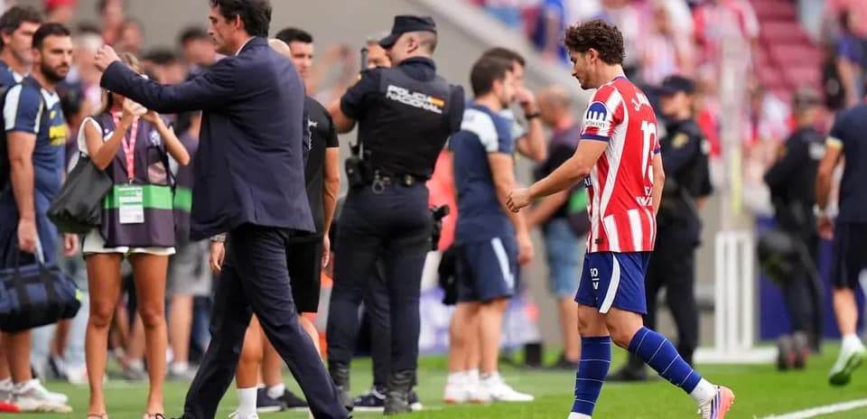Player walking off field as coach gestures