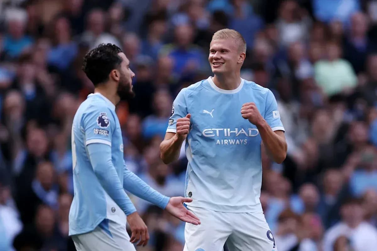 Manchester City players celebrating a goal on pitch