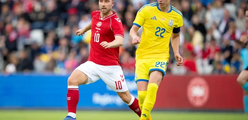 Denmark and Ukraine players competing for the ball